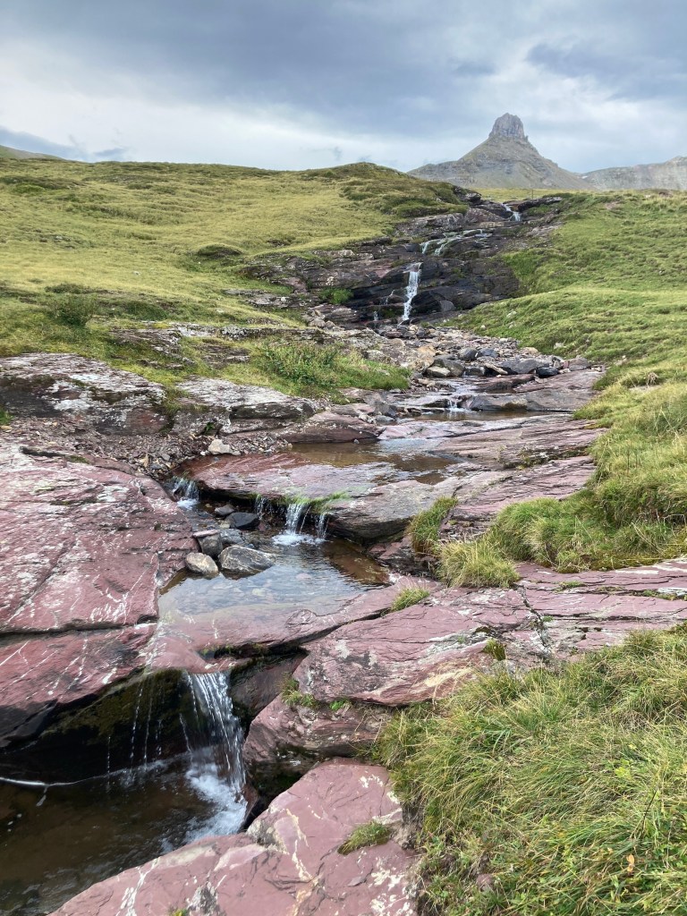Swiss mountains and a water stream. Photo by Helena J. /Abroadland